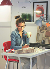 Woman holding mug browsing her phone.