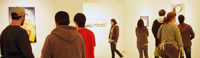 People looking at artwork in a gallery.