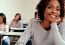 woman sitting in a classroom thinking about going to graduate school at Cal State East Bay.