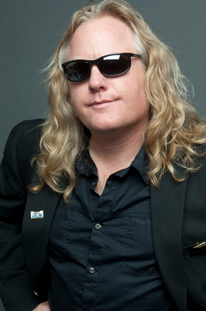 Head shot of Randy Monroe, CSUEB alumnus who is an award winning science teacher while also fronting a Van Halen tribute band