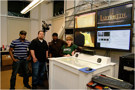 from left to right, CSUEB students Allister Willems,  Donald Torrez,  Kwame Oucho,  and Ozge Unsal Gascho in front of "Labyrinth Adventure"