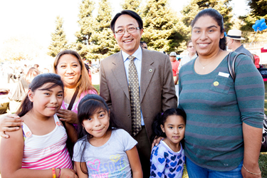 CSUEB President Leroy Morishita greets a local family at the Hayward Promise Neighborhood Community Festival. (By: Alex Lopez)