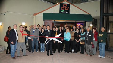 YiPing with red banner across the front door. (sanramon.org)