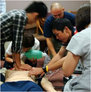 students working on a cardiac training dummy