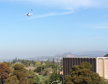 shuttle on 747 over gym building on campus