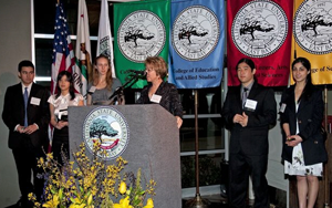 students receiving awards at podium