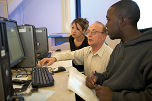 Students at computer with faculty member