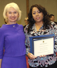 Carolyn Nelson (at left), dean of CSUEB's College of Education and Allied Studies, is shown congratulating a Promotora graduate. 