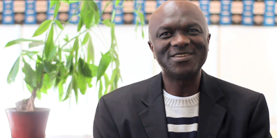 Man smiling in an office.