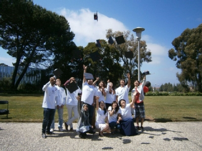 A group of people tossing their caps in the air.