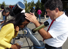 Science professor Gary Weston adjusts telescope for interested student. (By: Barry Zepel)