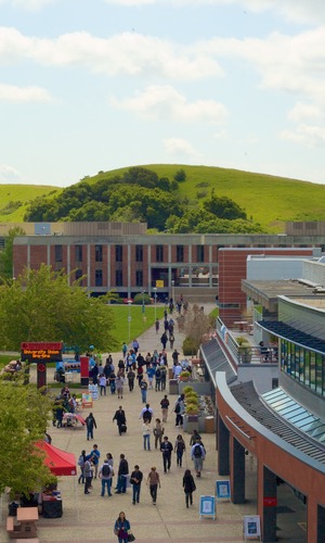 students walking in front of Hayward campus buildings