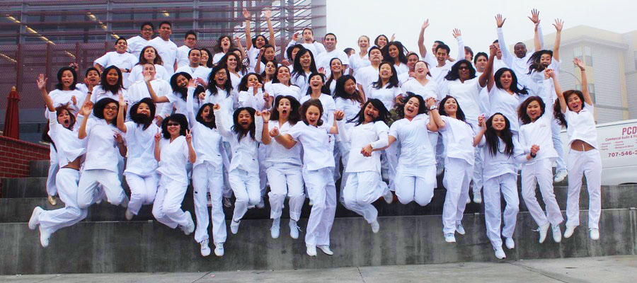 group of nursing students jumping and looking excited