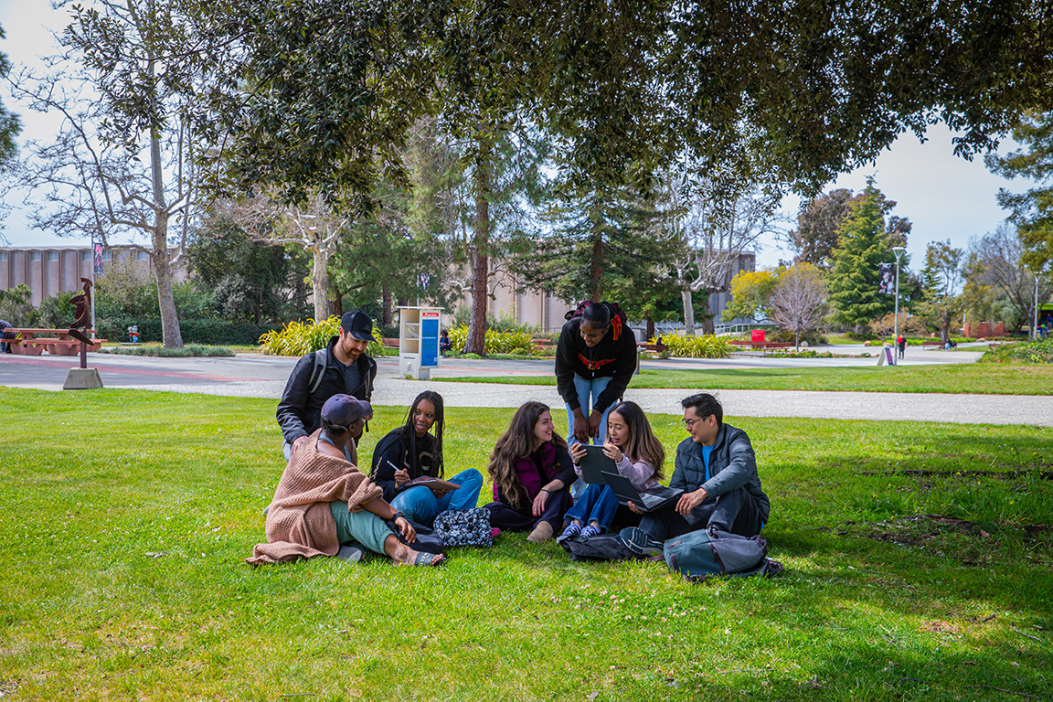 PHAP Students sittling on lawn.