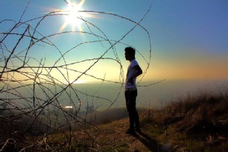 man standing on top of a hill