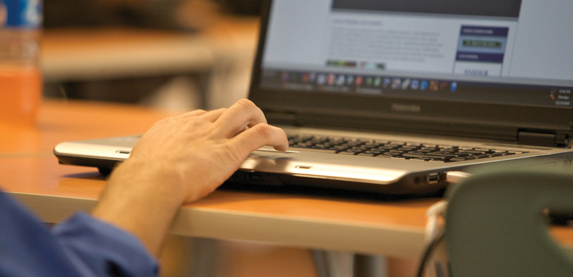 person's hands using laptop computer