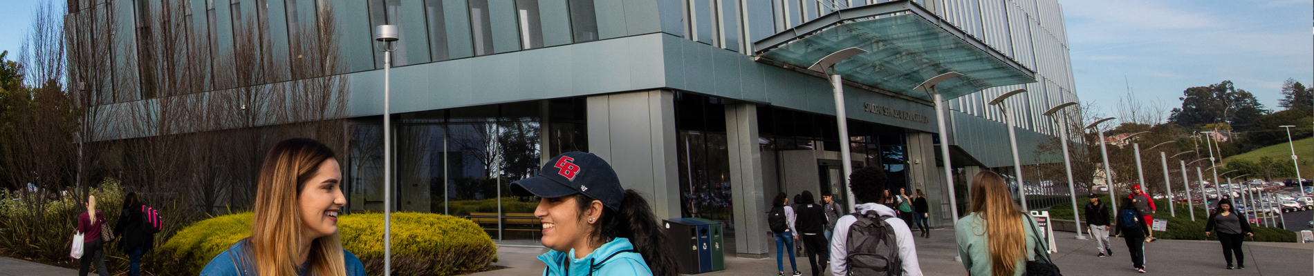 2 woman standing next to the SA building