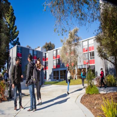  Students hanging out in front of Student Housing building