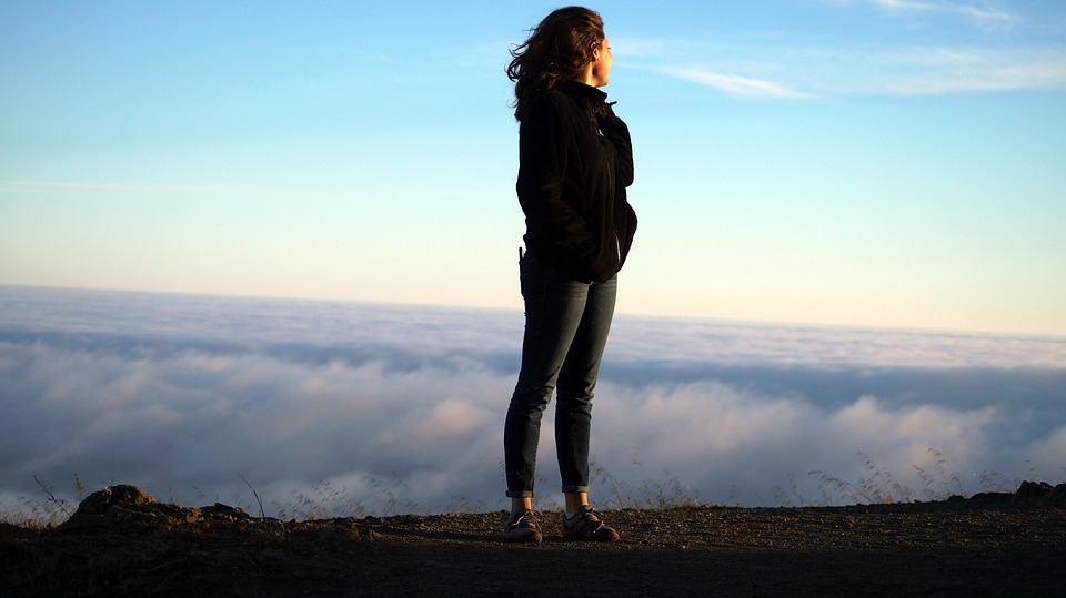 woman standing on mountain top