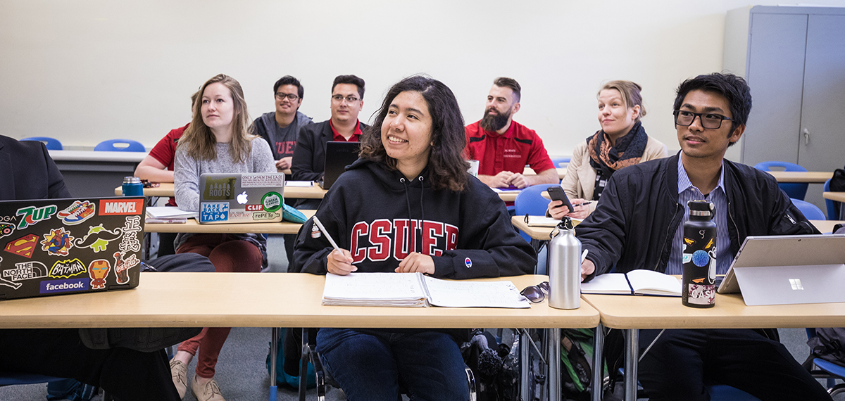 Several students sitting at tables in a classroom