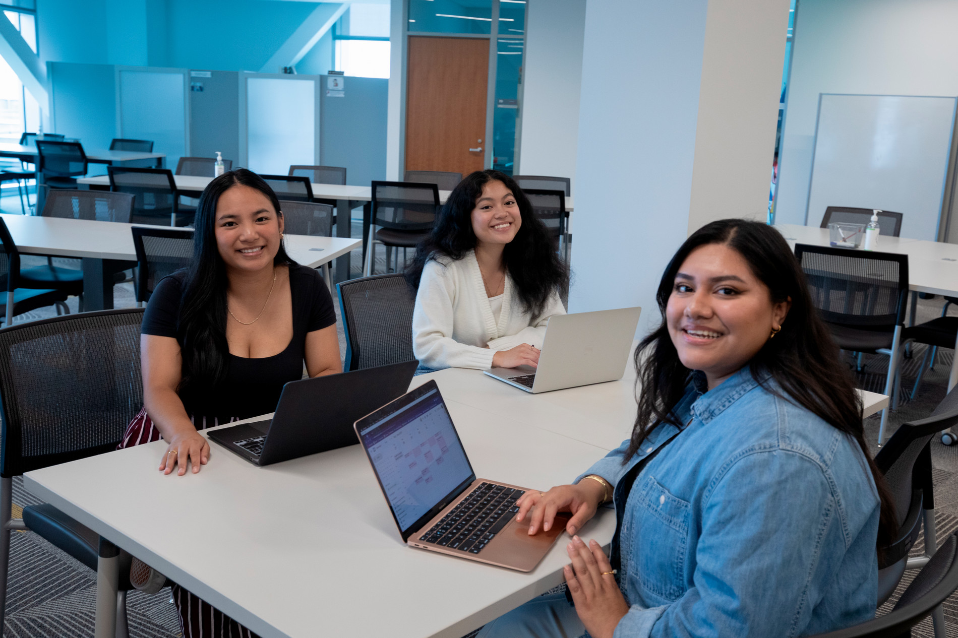 Several students sitting a table in the SCAA