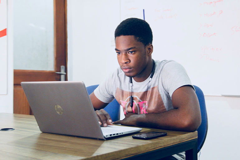 A student and a SCAA tutor working together on a laptop