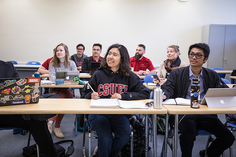 Several students sitting at tables in a classroom