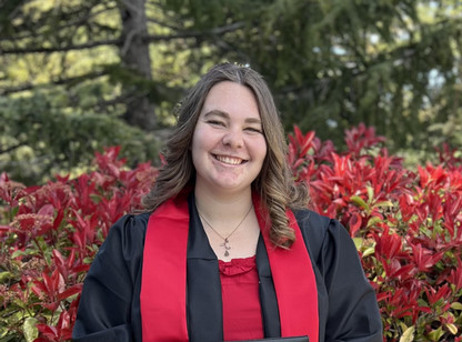 A photo of a person wearing CSU East Bay regalia