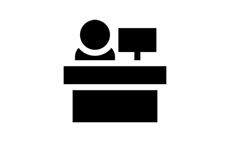 receptionist icon with a silhouette of a person sitting at a desk with a computer 