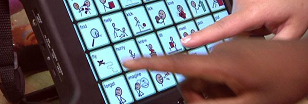 image of hands pointing to AAC device