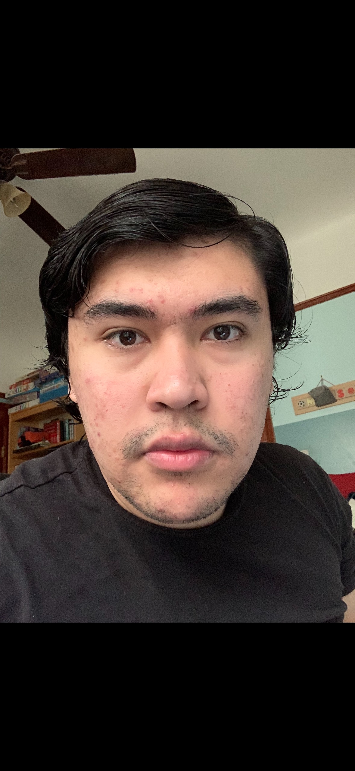 Picture of Moises, dark-haired Hispanic male standing in an office space. 