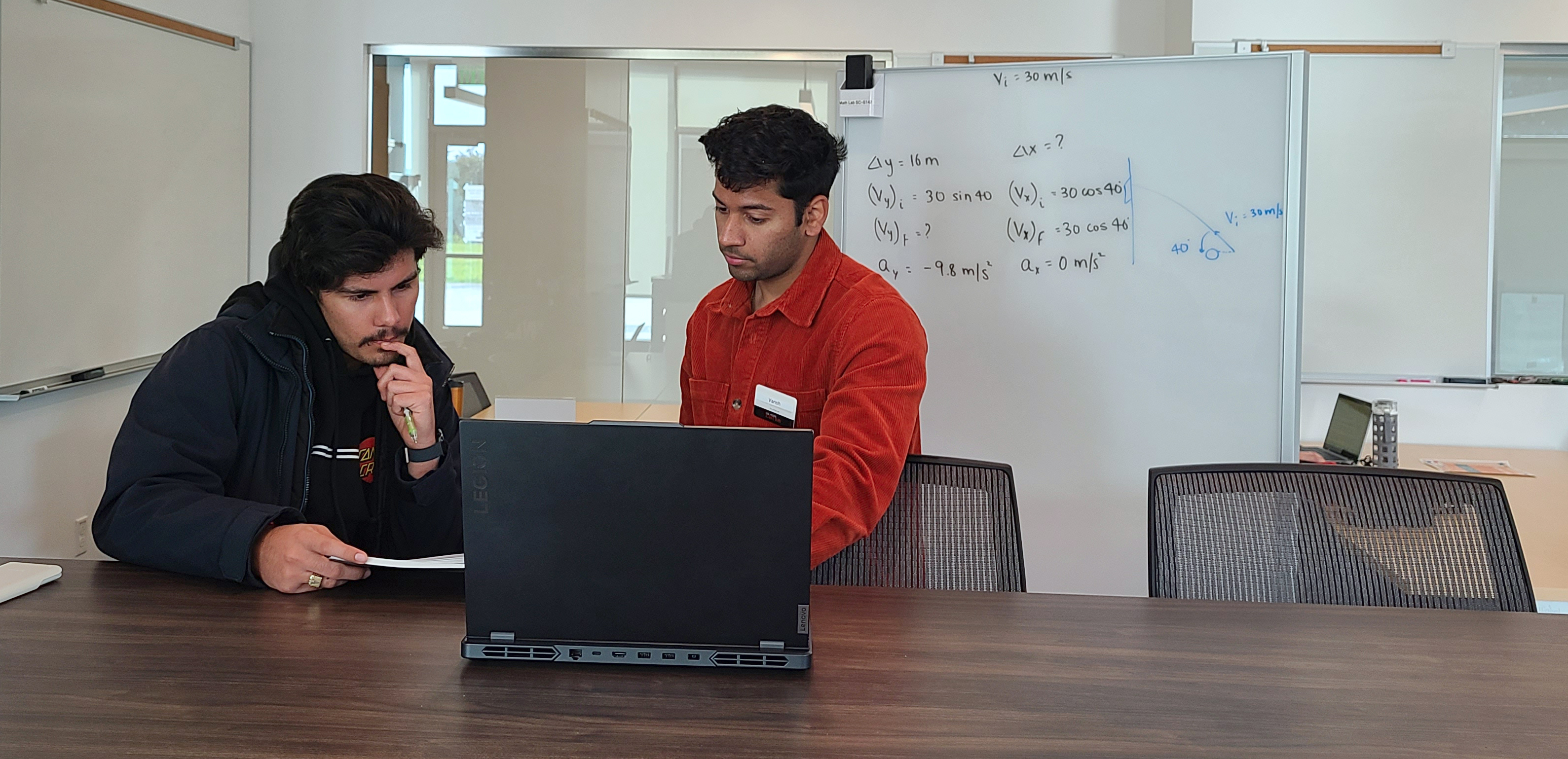 An LA and student working one on one during physics drop in support