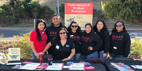 Students at information table supporting Undocumented students
