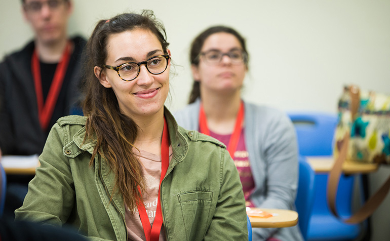 Student sitting in class smiles