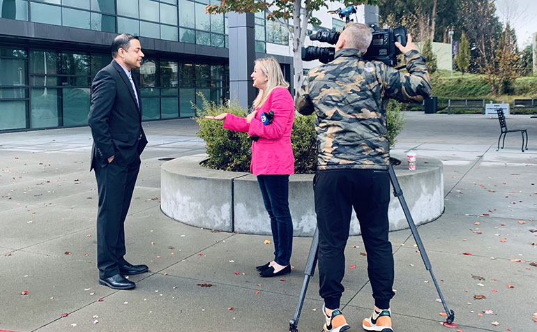 Faculty member is interviewed by news crew