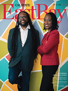 Two people standing in front of colorful background