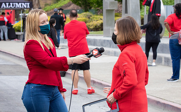 Reporter interviews President Sandeen