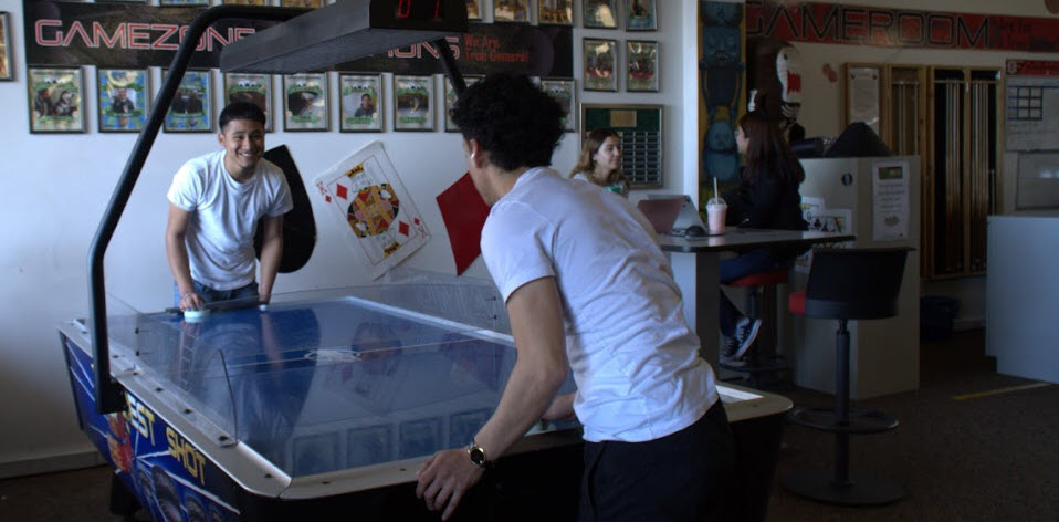 students playing air hockey 