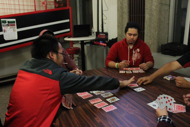 Students Playing Poker on a Circular Table