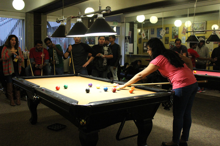 Student Taking a Shot on the Billiard Table