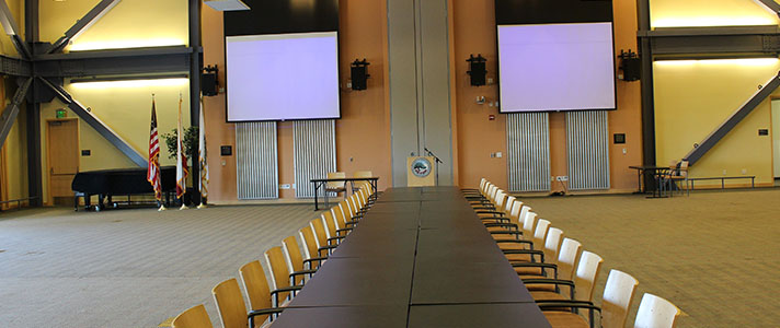 Long Rectangle Table with Chairs on the Outside and Podium up Front